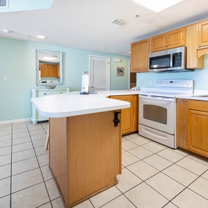 Cook and gather in this inviting kitchen with ample counter space and a cheerful color palette for a delightful stay