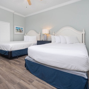 Drift into restful sleep on plush queen beds, embraced by a soothing vibe in this inviting guest room