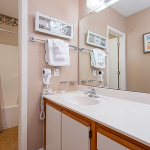 Enjoy the master bathroom with a large vanity, ample storage, and a relaxing tub-shower area