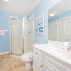 Additional bath featuring a walk-in shower, stylish decor, laundry area with washer/dryer, and a serene blue color palette