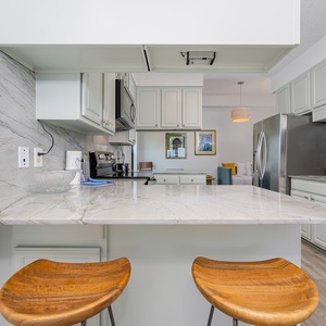 Kitchen featuring sleek stainless appliances and elegant marble countertops, perfect for culinary adventures