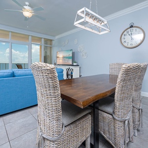 Gather around the rustic dining table, enjoying beachfront views from the balcony