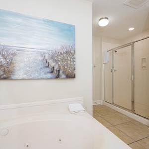 Refresh in the master bath after a day at the beach with a soothing jetted tub and relaxing walk-in shower