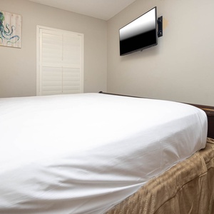 Unwind in this guest bedroom featuring a plush king bed and a flat-screen TV for entertainment