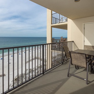Enjoy breathtaking views from the private balcony, featuring comfortable seating and a serene beachfront atmosphere