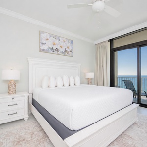 Inviting master bedroom with a king bed and stunning beach views from the balcony