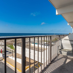 Enjoy stunning beachfront views from this inviting balcony, perfect for relaxing in the sun