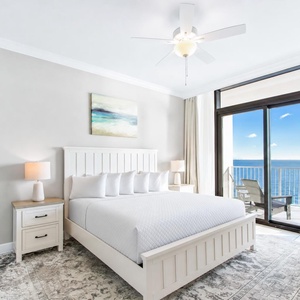 Serene master suite featuring a king bed, stylish decor, and stunning beachfront views from the the balcony