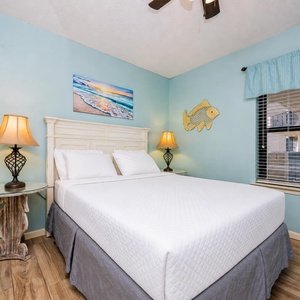Rest comfortably in the inviting guest bedroom with a queen bed, charming decor, and natural light from the window