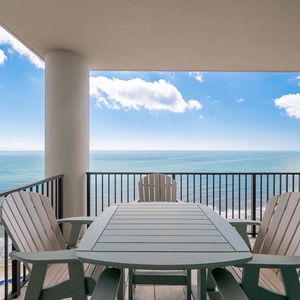 Enjoy stunning views from this inviting balcony with comfortable seating and a table, perfect for relaxation