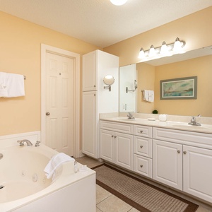 Indulge in relaxation in the master bath with a refreshing walk-in shower and soothing jetted tub