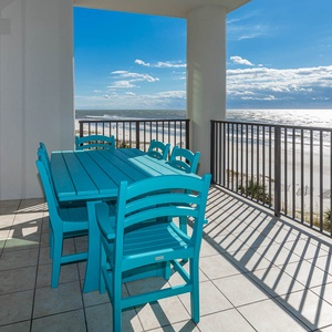 Enjoy dining on the vibrant turquoise patio set while taking in the beachfront and pool area view from this lovely balcony