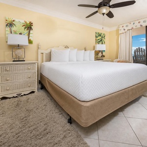 Experience comfort in the master bedroom with a king bed and direct access to the beachfront balcony