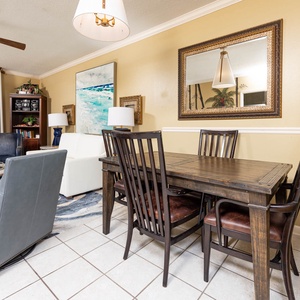 Enjoy meals at the rustic dining table, surrounded by tasteful decor and a cozy living area with beach views