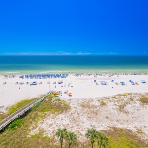 Breathtaking views of white sands and vibrant beach umbrellas create the perfect seaside escape