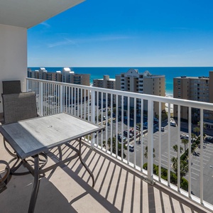 This balcony offers a stunning beach view with comfortable seating, perfect for relaxing and enjoying the scenery