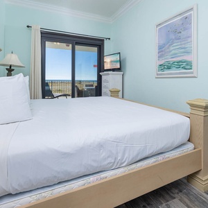 Brightly colored walls complement the master with an inviting king bed, while the extended balcony overlooks the beach