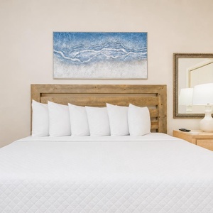 This king guest suite welcomes you to breathe in calm as you sink into plush pillows and fresh linens