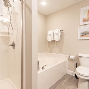 Refresh in the master bath after a day at the beach with a soothing jetted tub and relaxing walk-in shower