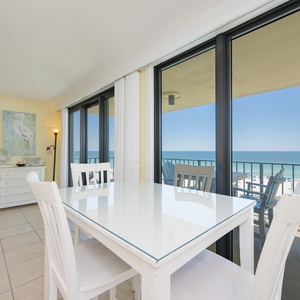 Natural light fills the dining area where you savor meals with the coast visible through glass doors