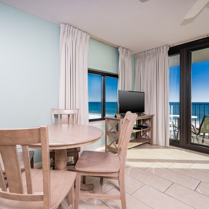 Enjoy meals at the round dining table while taking in the captivating view through the large glass doors