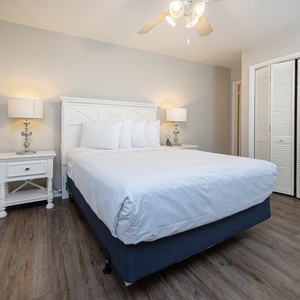 Guest bedroom featuring a plush queen bed, stylish decor, and warm lighting for a cozy retreat