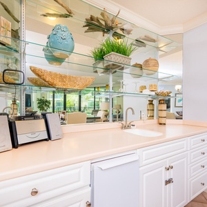 Enjoy refreshing drinks and good company at the charming wet bar, embracing a relaxed coastal vibe