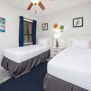 Twin guest suite lets you rest easily under gentle lamp light after a day along the shore