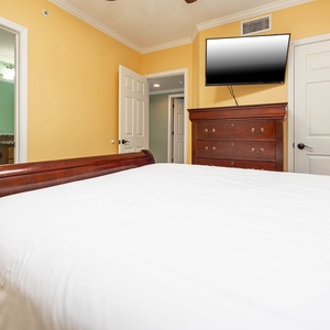 Relax in this guest bedroom featuring a comfortable queen bed, a TV, and easy access to a stylish bathroom