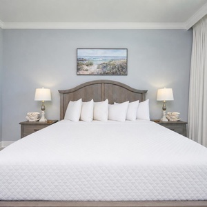 Experience restful nights in the master bedroom featuring a king bed, soft linens, and coastal decor