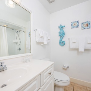 Rejuvenate in this guest bathroom, where plush towels and charming decor enhance your daily rituals
