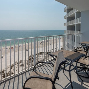 Enjoy breathtaking beachfront views from the balcony, complete with comfortable seating for relaxation