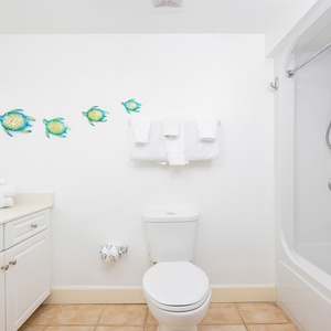 Experience rejuvenation in this guest bathroom, where plush towels await after a refreshing shower