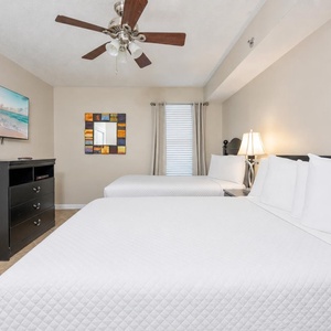 Rest in comfort in this guest room with a double and a twin bed, a TV for family movie nights and cheerful accents