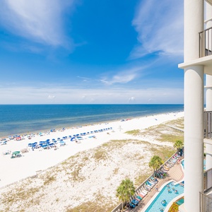 Enjoy captivating views from the spacious balcony overlooking the sparkling beach and inviting lazy river