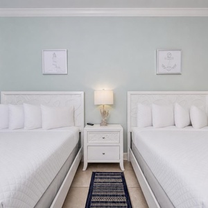 Two queen beds in the guest suite invite you to sink into peaceful rest after your beach adventures