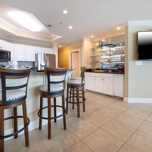 Sip your morning coffee at the breakfast bar and get ready for a beach day in this stylish space