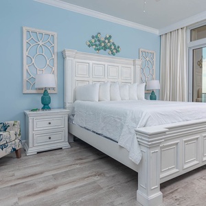 Retreat to the king master suite with cozy bedding and drift off to the sound of the waves from the balcony
