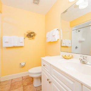 Rejuvenate in this sunny bathroom featuring plush towels, creating a welcoming space for your refreshing routine