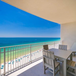 Relax on the spacious balcony with comfortable seating, enjoying expansive views of the tranquil waters below