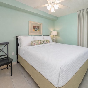 Unwind in this inviting bedroom featuring a comfortable king bed, soft lighting, and a serene color palette