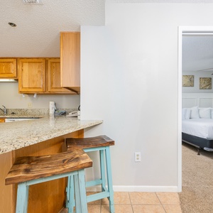 Enjoy casual meals at the breakfast bar with colorful stools and easy access to the kitchen