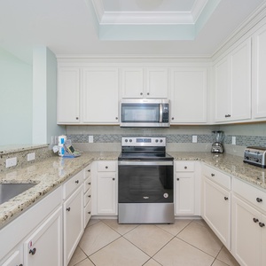 Create culinary delights in this stylish kitchen, where stainless appliances meet inviting countertop space