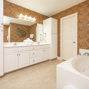 Refresh in the master bath after a day at the beach with a soothing jetted tub and relaxing walk-in shower