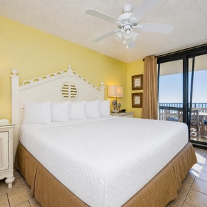 King bed in the master suite invites you to unwind while coastal views stretch beyond your balcony doors