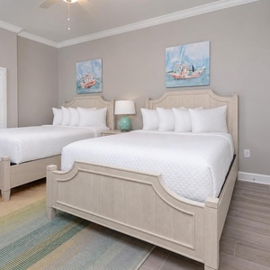 Drift off on the roomy queen beds and admire the coastal boat paintings in this guest suite