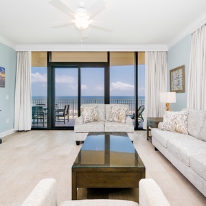 Relax in this living area with comfortable seating, queen sleeper sofa, and beachfront balcony access