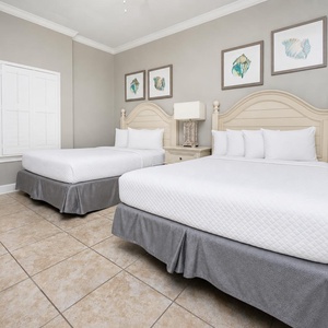 Relax in the guest bedroom, where two cozy queen beds promote restful nights and rejuvenating mornings