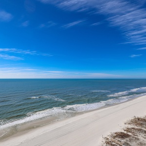 Gaze at the tranquil waves and expansive shoreline, perfect for leisurely strolls and relaxation