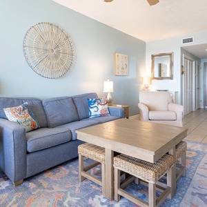 Relax on the comfortable sofa surrounded by coastal decor, perfect for unwinding after a day of adventure